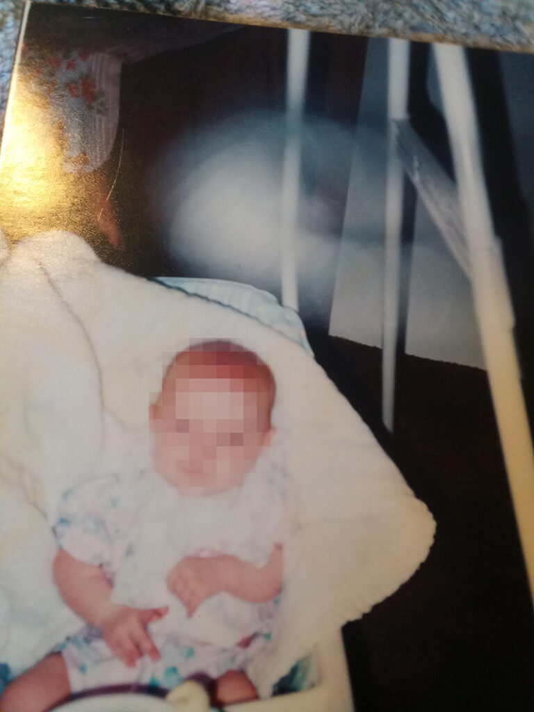 ghostly orb circles baby in rocker.