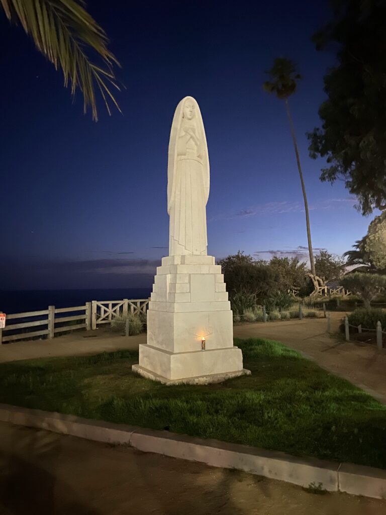 The 18 foot-high statue of Saint Monica in Palisades Park was erected in 1943. She faces the city at the foot of Wilshire Boulevard, her back to the sea.