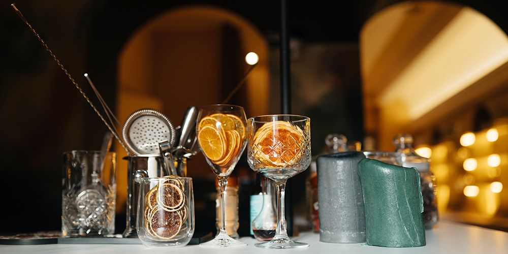 The back of a craft cocktail bar, displaying arcane ingredients, like those in our signature mixed drink, the Have A Spooky Day