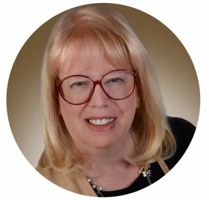 Headshot of Susan Reynolds, professional astrologer, wearing a friendly smile.