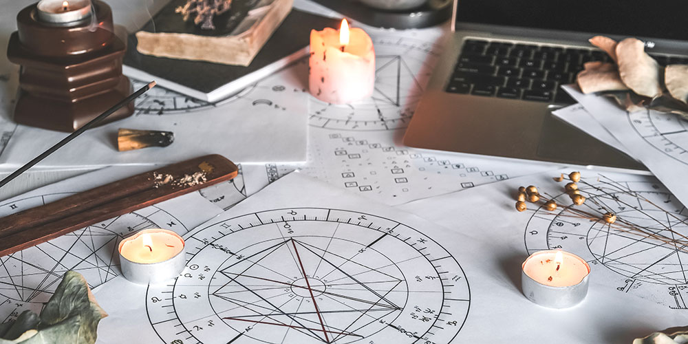 The image shows artistically rendered samples of astrology birth charts, which can provide insight into past lives, and how their past life karma is still affecting you.